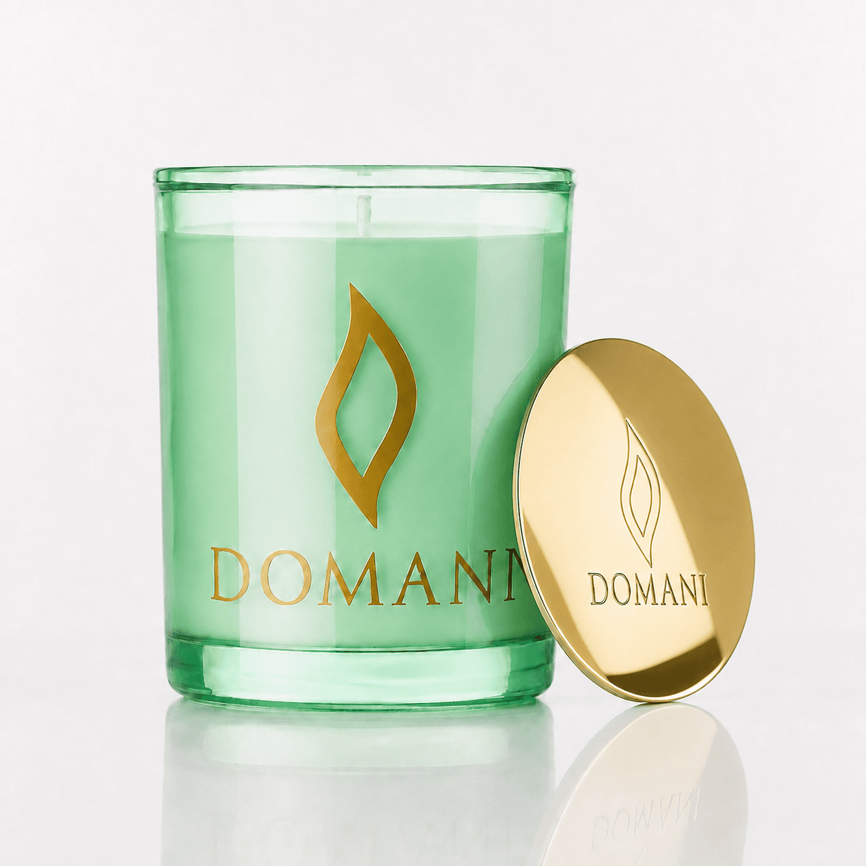 Domani Philos candle, Emerald · Lid off, unlit