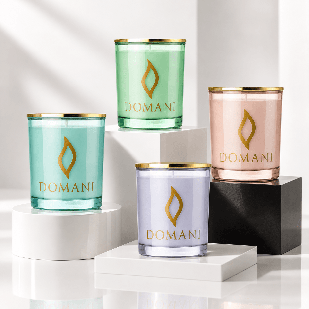 All four Domani candle colors: Emerald, Aquamarine, Rose Quartz and Sapphire