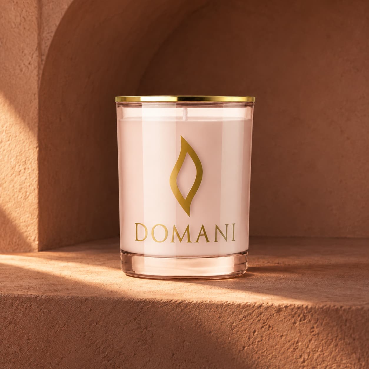 Domani seraphina candle in Rose Quartz glass, in a sunlit terracotta vault. Also available in the other three jar colors.