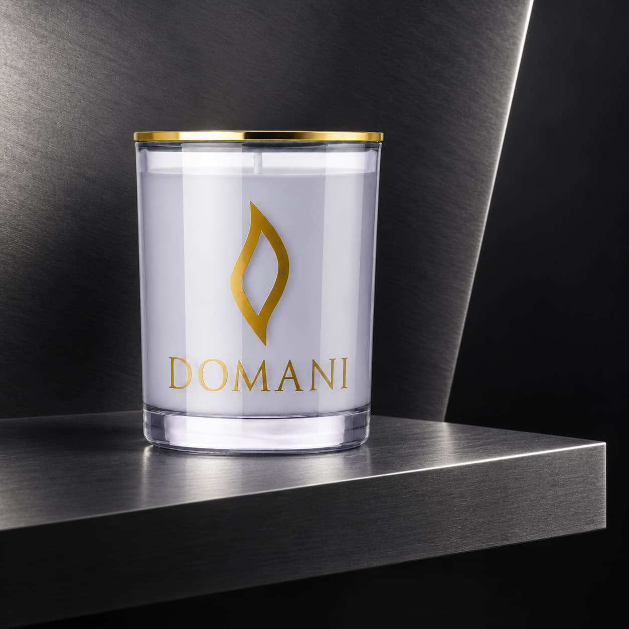 Domani sire candle in Sapphire glass, on a folded brushed-steel shelf. Also available in the other three jar colors.