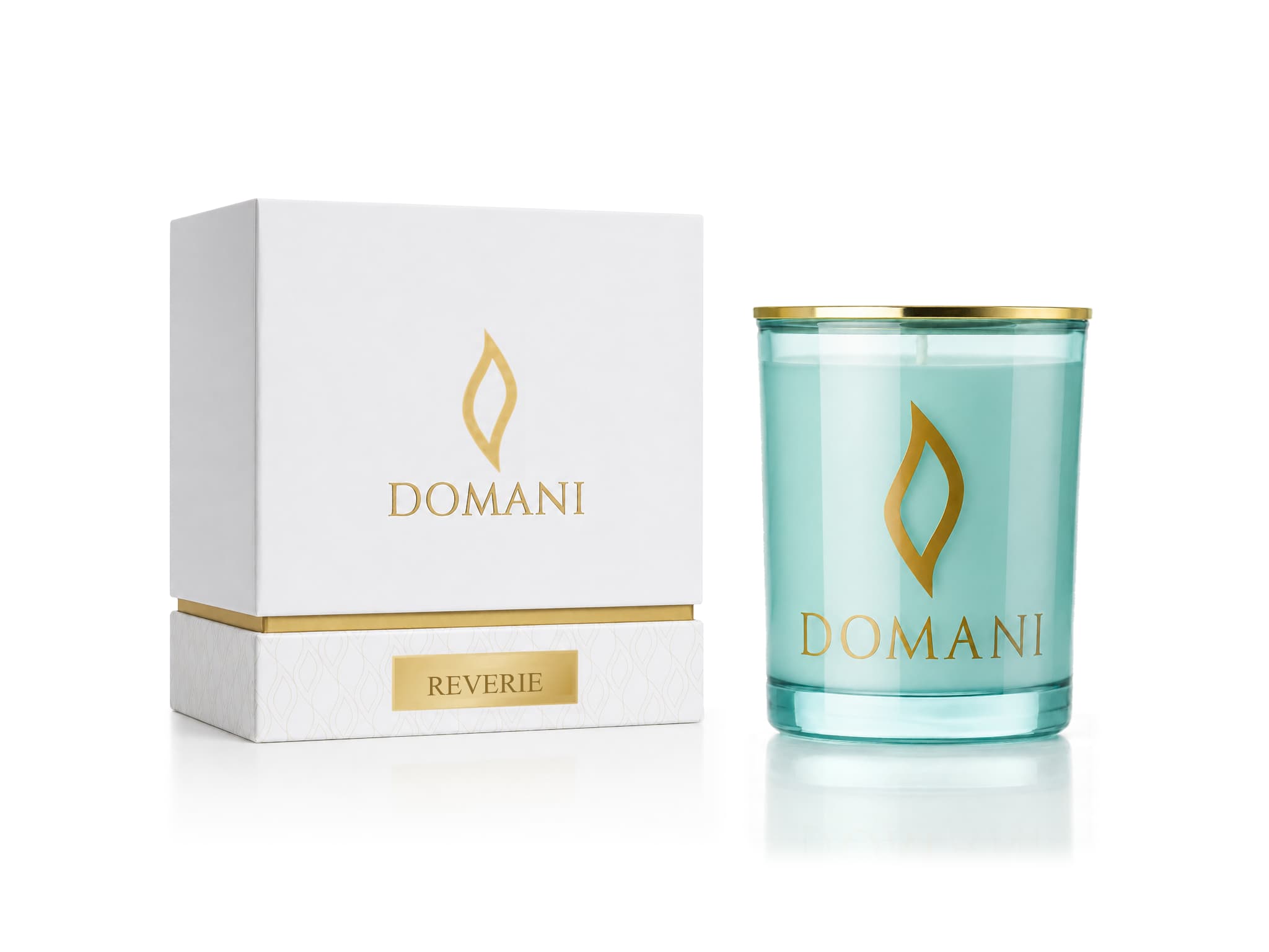 Reverie candle in Aquamarine glass beside its named presentation box.