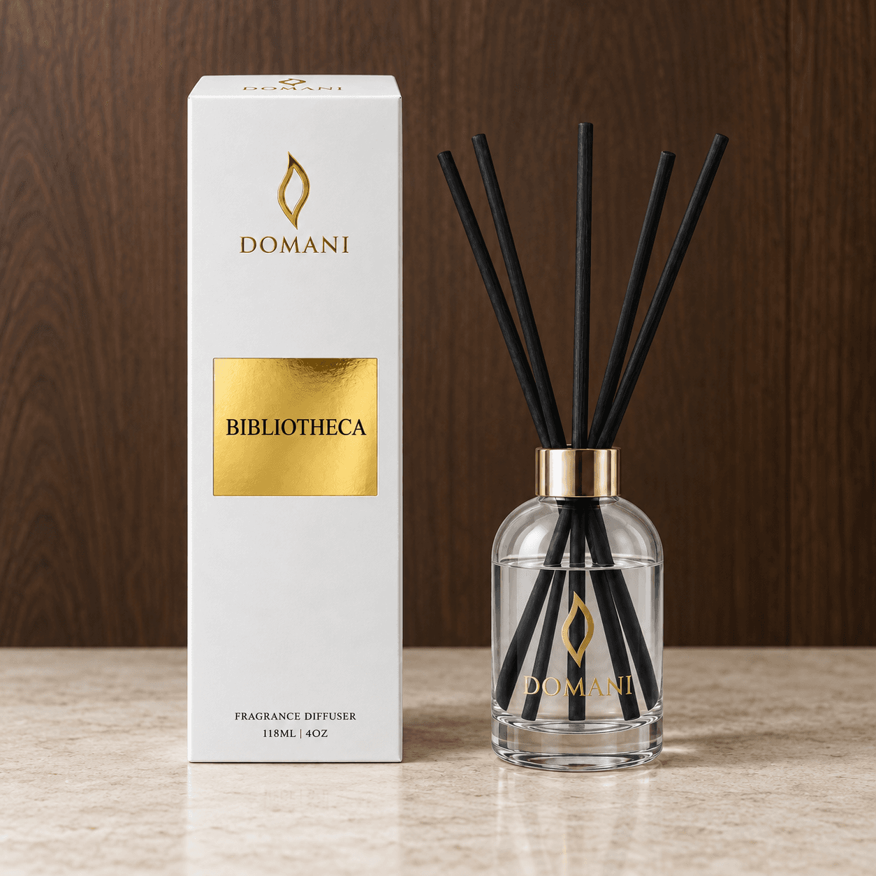 Bibliotheca reed diffuser with five reeds beside a carton bearing its fragrance name