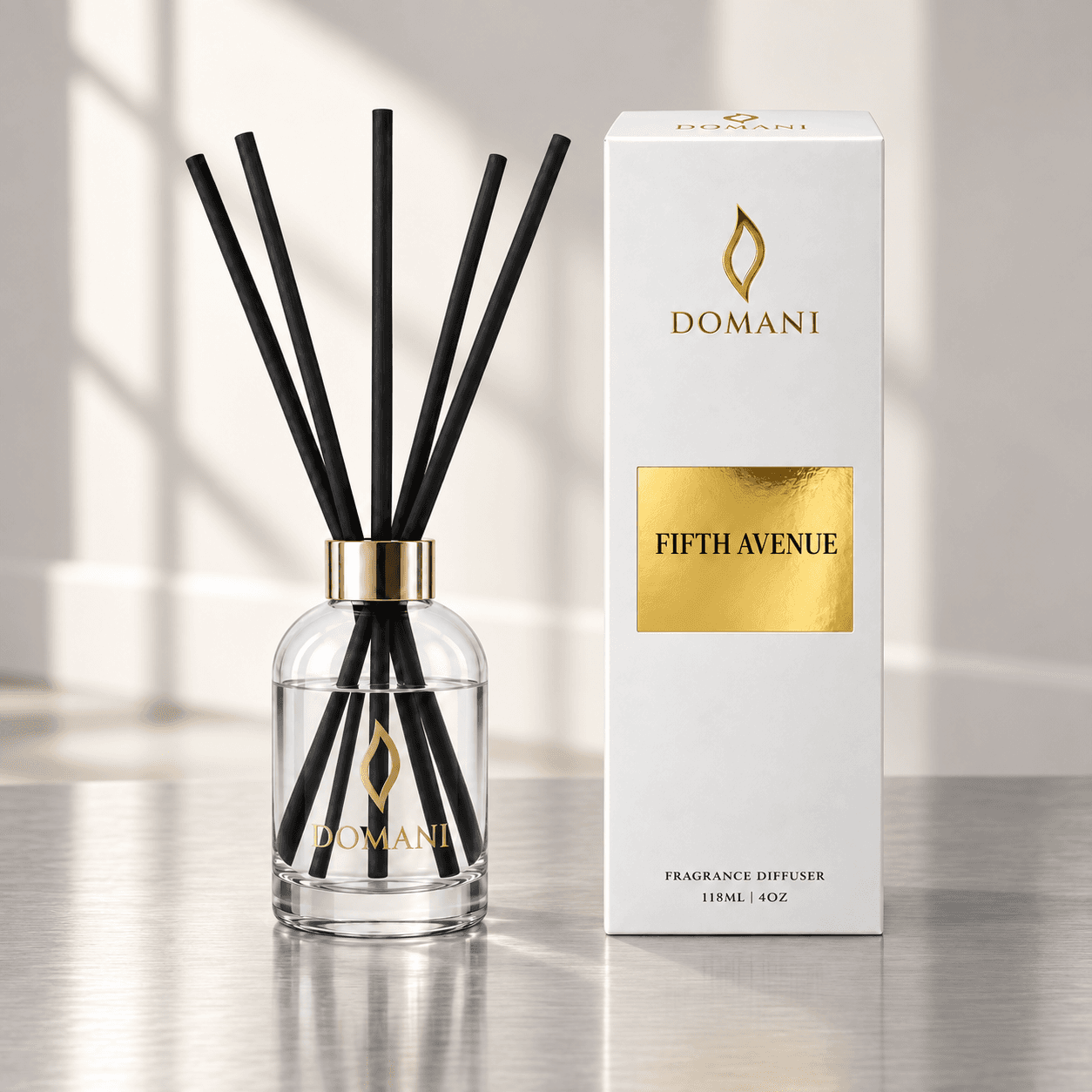 Fifth Avenue reed diffuser with five reeds beside a carton bearing its fragrance name