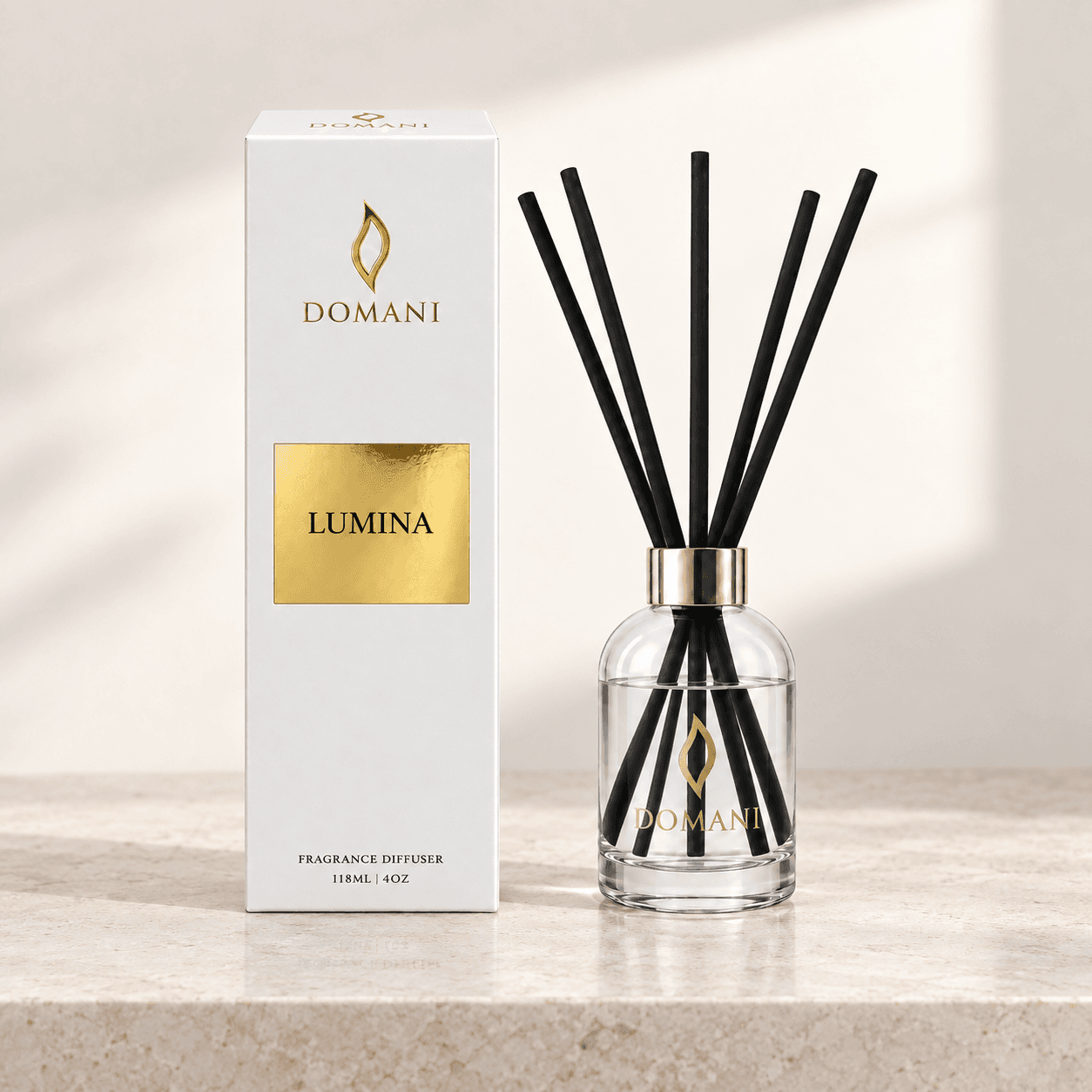 Lumina reed diffuser with five reeds beside a carton bearing its fragrance name