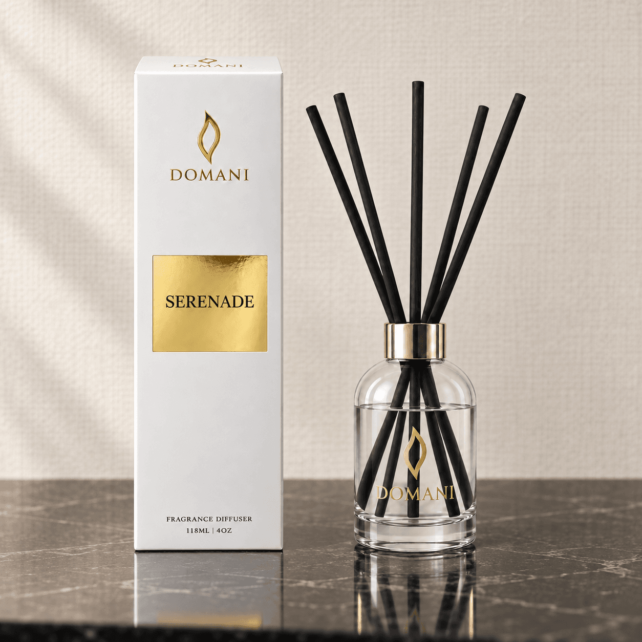 Serenade reed diffuser with five reeds beside a carton bearing its fragrance name