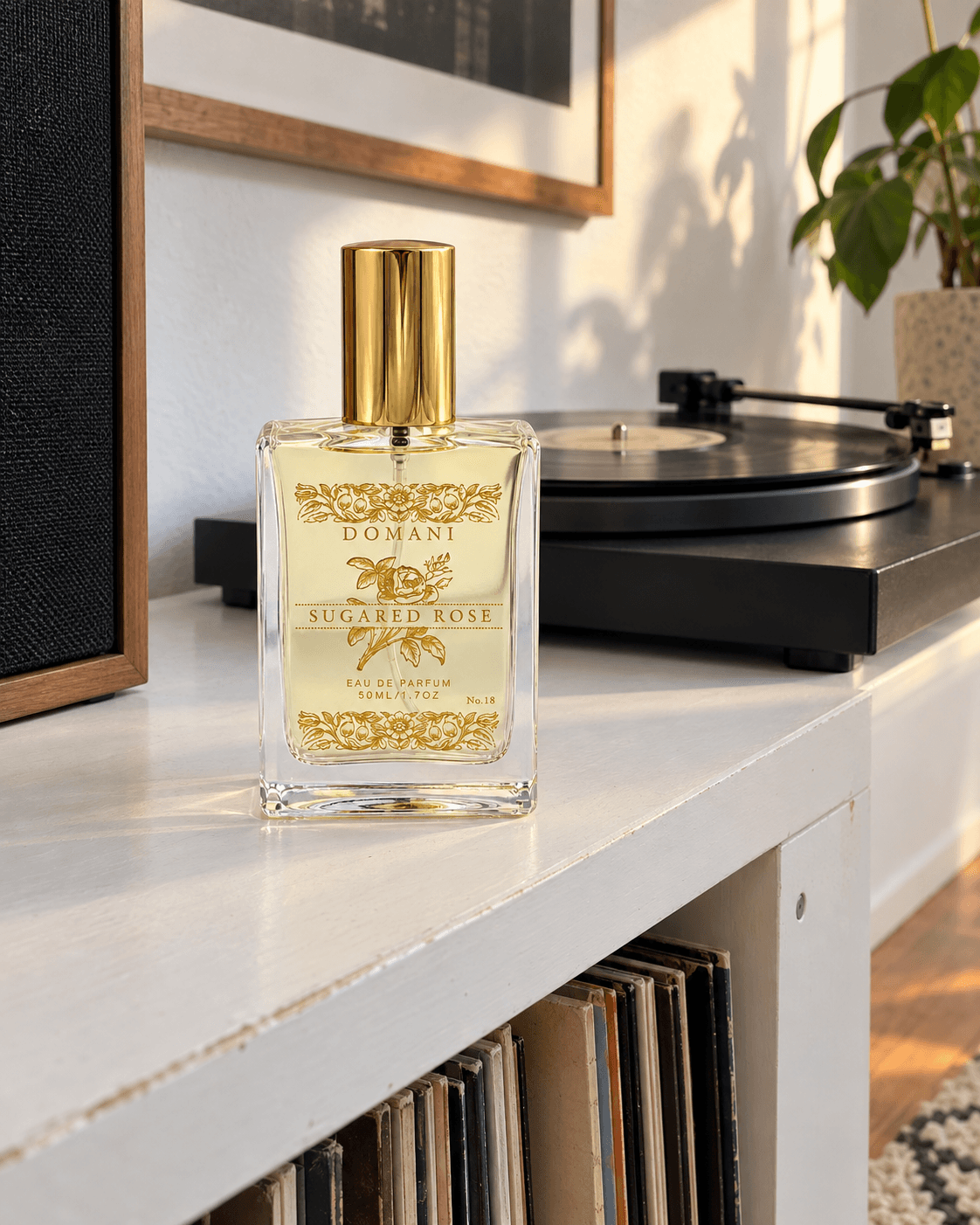 Sugared Rose 50 ml eau de parfum with gold rose artwork, capped on a white record cabinet with a turntable behind.