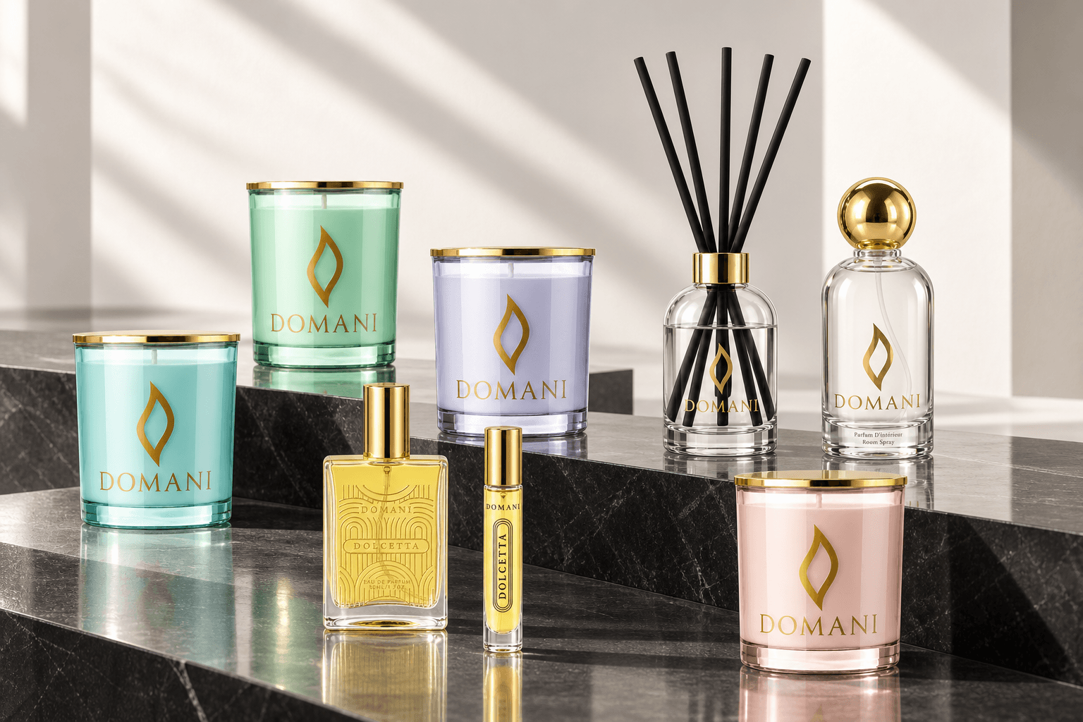 Domani candles in four glass colors, Dolcetta perfume in full and travel sizes, a reed diffuser and a room spray on black stone ledges